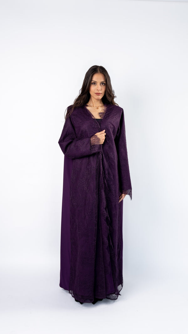 Woman wearing a long purple dress on a white background