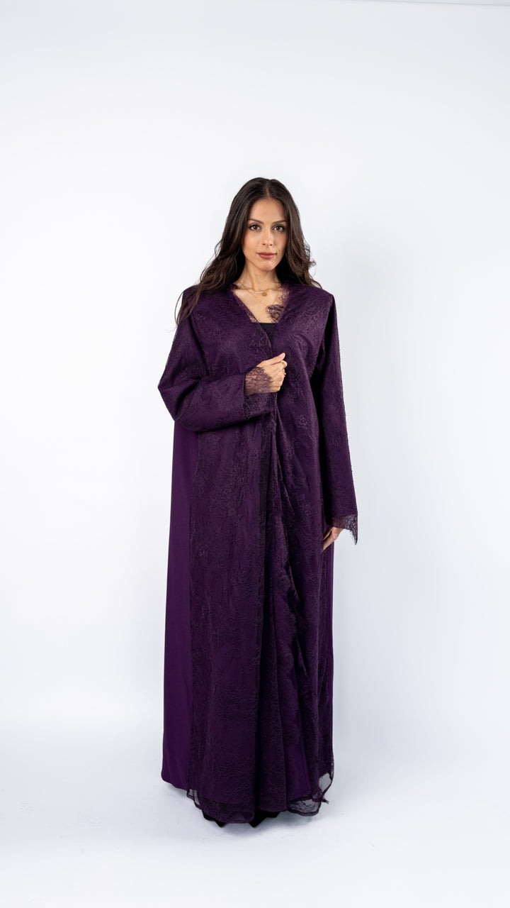 Woman wearing a long purple dress on a white background